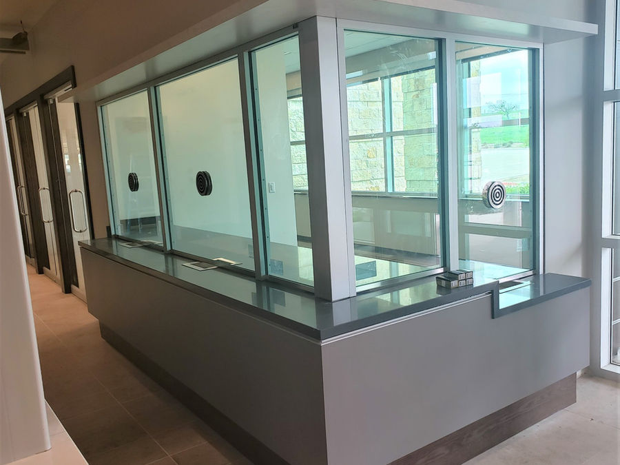 Bulletproof transaction glass window at commercial reception counter