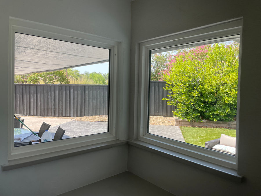 Residential corner windows with backyard view